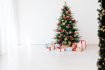 Garland Christmas tree pine with gifts for the new year decor interior red white