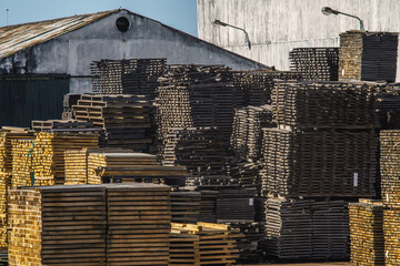 Stacks of wooden boards in a cooperage or barrel factory.