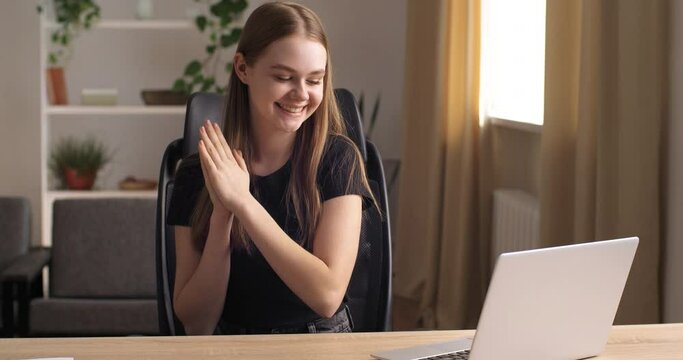 Portrait of young girl teenager sit at table read email use laptop feel happy. Student got scholarship confirmation, gambler win money on-line lottery victory, great news sincere reaction, sucsess