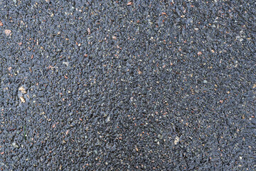 Dark texture of asphalt, wet road surface.