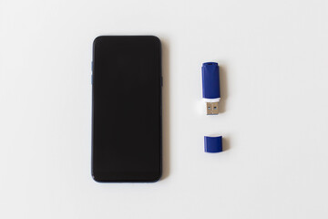 phone and flash drive on a white background