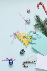 Merry Christmas, New Year's toys, fir branches on a light blue background, concept of congratulations, postcard