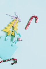 Merry Christmas, New Year's toys, fir branches on a light blue background, concept of congratulations, postcard