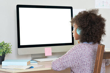 African american elementary school kid girl wearing headphones virtual distance learning online...
