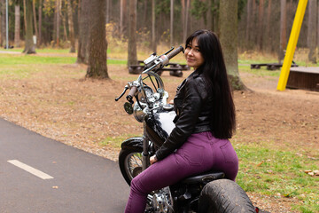 Fototapeta na wymiar beautiful brunette on a motorcycle on the track
