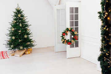 Fototapeta premium Christmas tree pine with gifts for the new year of the white room 2021 2022