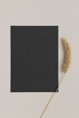 Black invitation card mockup with a dried  branch. 5x7 ratio, similar to A6, A5.