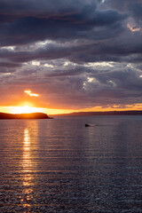 Kea, Tzia island, destination Greece. Sunset, sunrise orange through clouds background.