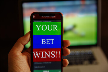 Man celebrating money win at bookmaker's website.