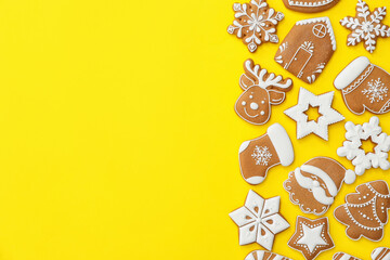Different Christmas gingerbread cookies on yellow background, flat lay. Space for text