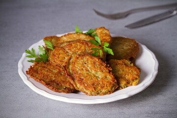 Potato cakes. Vegetable fritters, pancakes, latkes on white plate
