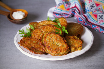 Potato cakes. Vegetable fritters, pancakes, latkes on white plate