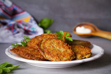 Potato cakes. Vegetable fritters, pancakes, latkes on white plate