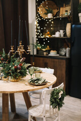 Festive kitchen in Christmas decorations. Christmas dining room. Beautiful New Year decorated classic home interior.  