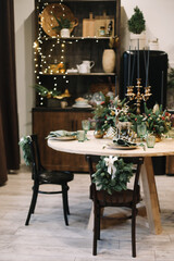Festive kitchen in Christmas decorations. Christmas dining room. Beautiful New Year decorated classic home interior.  