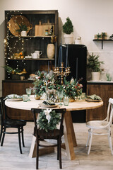 Festive kitchen in Christmas decorations. Christmas dining room. Beautiful New Year decorated classic home interior.  