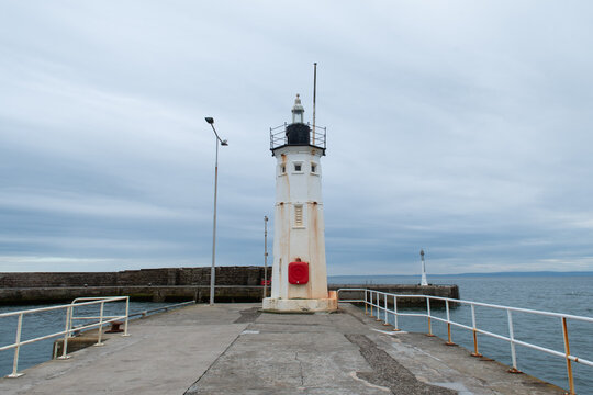 Anstruther lighthouse in Scotland. Horizontal photograph. Cloudy day.