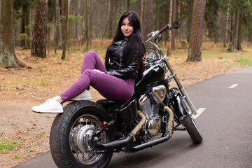 Obraz na płótnie Canvas Happy girl on a motorcycle