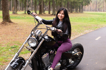 Fototapeta na wymiar Happy girl on a motorcycle