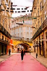 Young female traveller on a Pink Street in Lisbon, Portugal