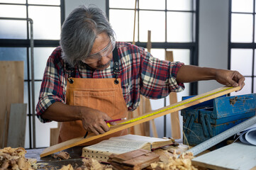 Carpenter working on DIY wood craft at workshop to construct material or wooden furniture in carpentry concept