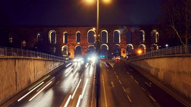 Time lapse clip near Valens Aqueduct (Bozdogan Su Kemeri) in evening with traffic of cars, Istanbul, Turkey. It was a water-providing system of the Eastern Roman capital Constantinpole