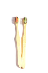 Eco-friendly bamboo toothbrushes on white background. Natural organic product concept. Flat lay, top view, copy space