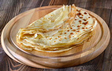 Crepes on wooden board