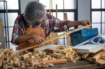 carpenter is selecting wood for making furniture, wooden handcraft working at home