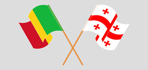 Crossed and waving flags of Mali and Georgia