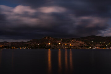 long exposure shot that includes sea, mountain, clouds. sunset or sundown landscape image from Izmir, Turkey.