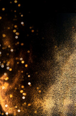 Fototapeta na wymiar Abstract dark background with golden sparkles. Blurred effect. Concept for festive background or for project.