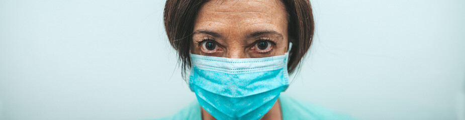 Portrait of a female doctor therapist covered by facemask.