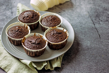 Homemade gluten-free muffins with chocolate close-up. Gluten-free flour cupcakes with chocolate on a green plate with a napkin on a dark table. Low Carb Sugar Free Cupcakes