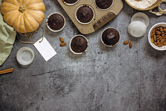 Homemade gluten-free pumpkin muffins with chocolate in a baking dish, top view, flat lay, copy space