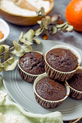 Homemade gluten-free muffins with chocolate close-up. Gluten-free flour cupcakes with chocolate on a green plate with a napkin on a dark table. Low Carb Sugar Free Cupcakes