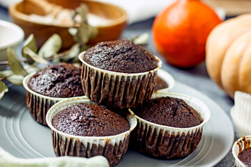 Homemade gluten-free muffins with chocolate close-up. Gluten-free flour cupcakes with chocolate on a green plate with a napkin on a dark table. Low Carb Sugar Free Cupcakes
