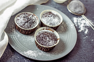 Homemade gluten-free muffins with chocolate close-up. Gluten-free flour cupcakes with chocolate on a green plate with a napkin on a dark table. Low Carb Sugar Free Cupcakes