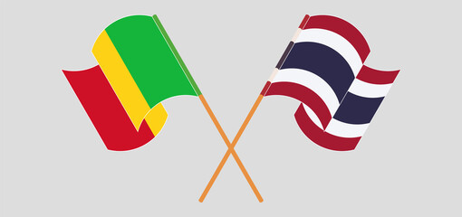 Crossed and waving flags of Mali and Thailand