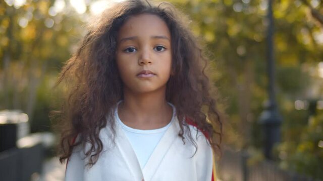 Portrait of beautiful mixed race kid on landscape background