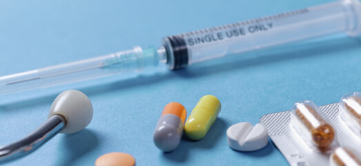 Medical syringe with a needle and pills. Corona virus vaccine.