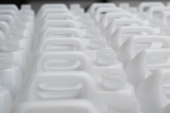Rows of white plastic canisters ready to be filled with chemicals
