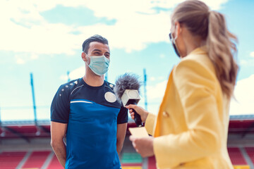 Reporter doing interview with football player during covid-19