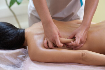 Caucasian woman getting a back massage in the spa salon