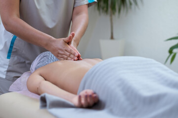 Obraz na płótnie Canvas Caucasian woman getting a back massage in the spa salon