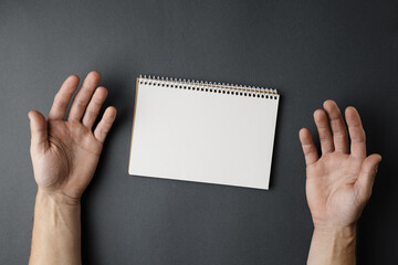 Open notebook and male hands.