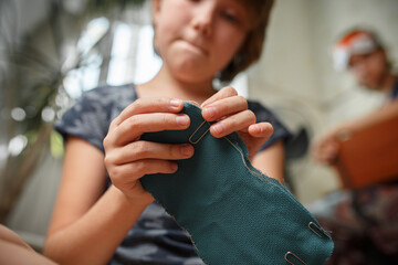 Girl sews a sleep mask from fabric. Handmade hobby