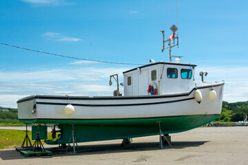 Naklejka premium Fishing boat - Fishing boat docked on dry land on Cape Breton Island, Nova Scotia, Canada.