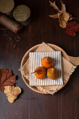 Top View of Three Fresh Pears on a Wooden Tray in a Rustic Setting