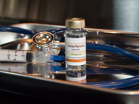 Vial of interferons injection with stethoscope and syringe